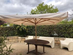 a table with an umbrella on a patio at Oasi Bochini in Avola