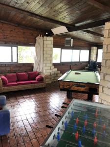 a living room with a pool table and a couch at Oasi Bochini in Avola
