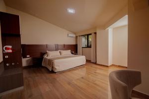 Postel nebo postele na pokoji v ubytování Hotel Sirari By Regina