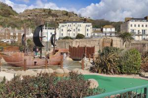 a water park with a pirate ship in a city at Master accommodation suite 2 sea view with balcony in Hastings