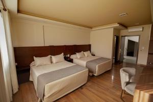 Postel nebo postele na pokoji v ubytování Hotel Sirari By Regina