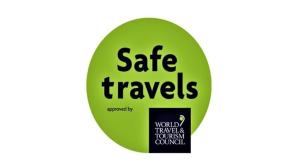 a green sticker with the words safe travels on it at Fare D'hôtes Tutehau in Papeete
