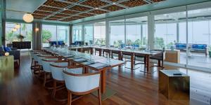 a dining room with tables and chairs and windows at InterContinental Cascais-Estoril by IHG in Estoril