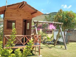 a small wooden house with a swing in a yard at Casa Matilde in Matilde