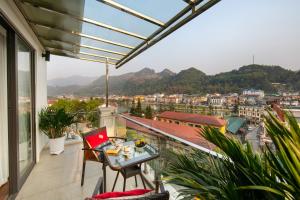 a balcony with a table and a view of a city at Sapa Mountain Queen House in Sa Pa