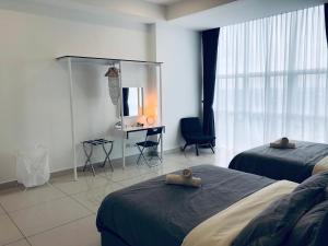 a hotel room with two beds and a desk at KSL Desplanade By Antlerzone in Johor Bahru +82 photos