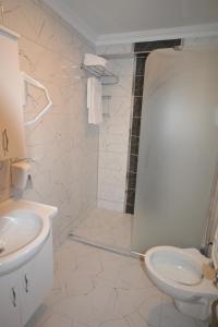 a white bathroom with a sink and a toilet at karasu elmasotel in Sakarya