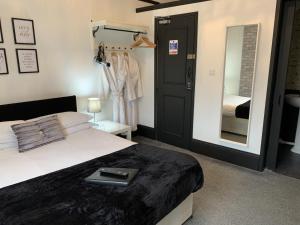 a bedroom with a bed with a book on it at Kingsmere Guest House in South Shields