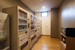 a vending machine in a store with drinks at Hotel Route-Inn Isesaki Inter in Isesaki