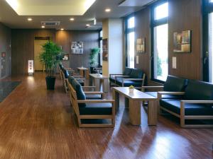 a waiting room with couches and tables in a hospital at Hotel Route-Inn Shimizu Inter in Shizuoka