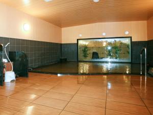 a room with a dance floor with a large screen at Hotel Route Inn Ishinomaki Chuo in Ishinomaki