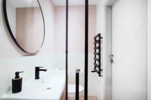 a bathroom with a sink and a mirror at Gliwice on a budget 90m from the main square in Gliwice