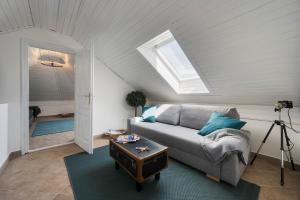 a living room with a couch and a skylight at Bella Ciao in Badacsonytomaj