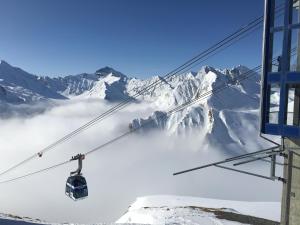 a ski lift in front of a snow covered mountain at Arina Apartments in Samnaun