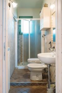 a bathroom with a shower and a toilet and a sink at Casale Vittoria in Atri