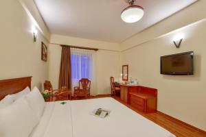 Postel nebo postele na pokoji v ubytování Khách sạn Park Hotel Dalat
