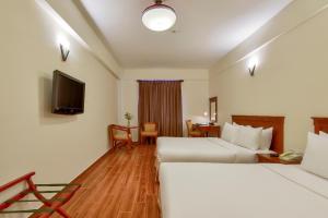 Postel nebo postele na pokoji v ubytování Khách sạn Park Hotel Dalat
