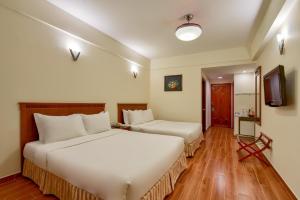 Postel nebo postele na pokoji v ubytování Khách sạn Park Hotel Dalat