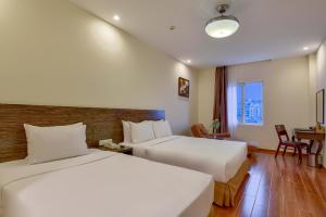 Postel nebo postele na pokoji v ubytování Khách sạn Park Hotel Dalat