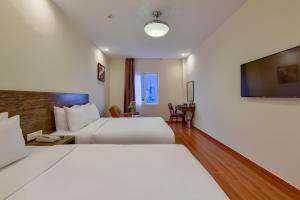 Postel nebo postele na pokoji v ubytování Khách sạn Park Hotel Dalat