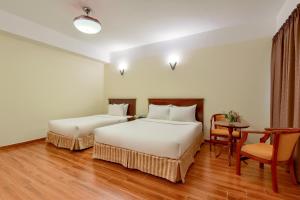 Postel nebo postele na pokoji v ubytování Khách sạn Park Hotel Dalat