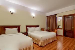 Postel nebo postele na pokoji v ubytování Khách sạn Park Hotel Dalat