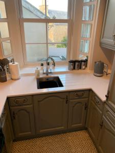 a kitchen with a sink and a window at The Teviot in the centre of Melrose in Melrose