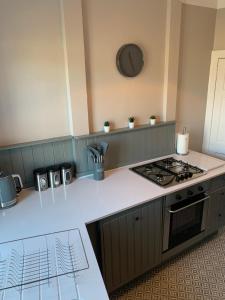 a kitchen with a stove and a counter top at The Tweed in the centre of Melrose in Melrose