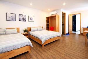 Postel nebo postele na pokoji v ubytování Nếp Apartment Hotel