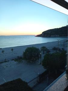 a view of a beach from a balcony at Wave n' Sea Apartments in Himare