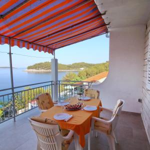a dining room with a table and a view of the water at Apartments Bacic in Prizba