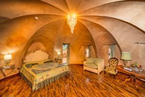 a bedroom with a bed and a chair in a room at Hotel Porto Pirgos in Parghelia