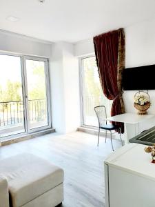 a living room with large windows and a couch at Coral Residence -Mamaia Nord in Mamaia