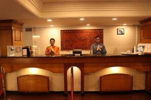 two men standing at a bar in a restaurant at Fortune Park Galaxy, Vapi - Member ITC's Hotel Group in Vapi