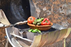 a basket of tomatoes and other vegetables on a grill at Finca Barralina in Campos