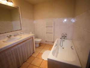 a bathroom with a tub and a sink and a toilet at Casa Carrer de Bonany in Sóller +26 photos