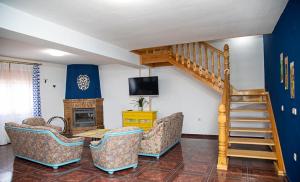 a living room with a couch and a staircase at Casa Rural Cece 4estrellas in Puebla del Salvador