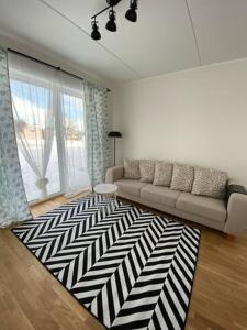 a living room with a couch and a rug at Overnight Family Home in Petrikyula