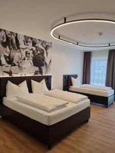 a bedroom with two beds and a chandelier at RINGRAST Boxenstopp mit HERZ in Spielberg