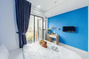 a teddy bear sitting on a bed in a bedroom at Harmony Homestay in Danang