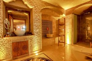 a bathroom with a sink and a toilet and a mirror at Göreme Rock Cave in Göreme +81 photos