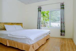een slaapkamer met een groot bed en een raam bij Trang An Pristine View homestay in Ninh Binh +27 foto's
