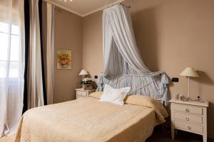 a bedroom with a bed with a canopy and a window at Agriturismo Poggio Il Castellare in Montalcino