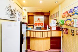 a fast food restaurant with a counter with an omega sign at OYO 89958 Hotel Umimas in Lahad Datu