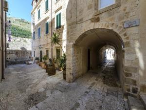 an alley with an archway in a stone building at Apartments Franka Old Town in Dubrovnik