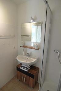 a bathroom with a sink and a shower at Nina in Wenningstedt