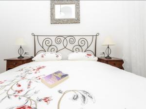 a bedroom with a bed with a book on it at Apartments Franka Old Town in Dubrovnik