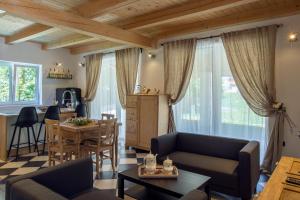 a living room with a couch and a table at 9b-The Resort in Sežana