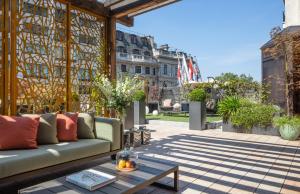 a patio with a couch and a table at Four Seasons Hotel London at Park Lane in London
