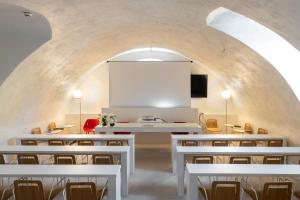 a dining room with white tables and chairs at Hotel Borgo Brianteo in Ponte San Pietro